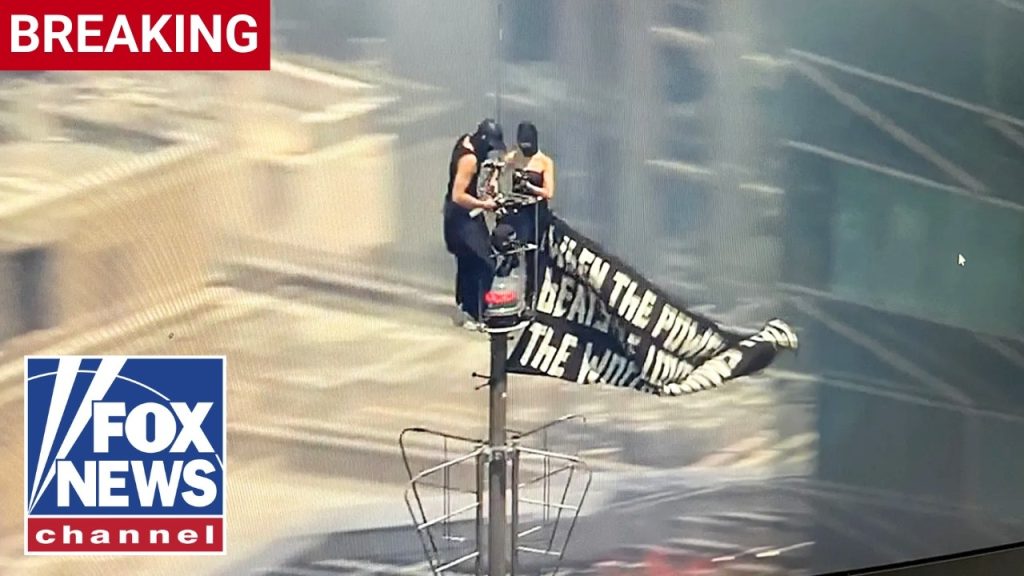 BREAKING: Protesters CLIMB Empire State Building spire
